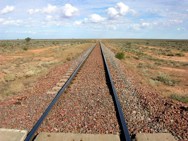 Transcontinental railway (Sydney to Perth, 4,352km, 3 days/nights travel!) crossing near Coondambo Station. This railway includes the world's longest straight of 478km