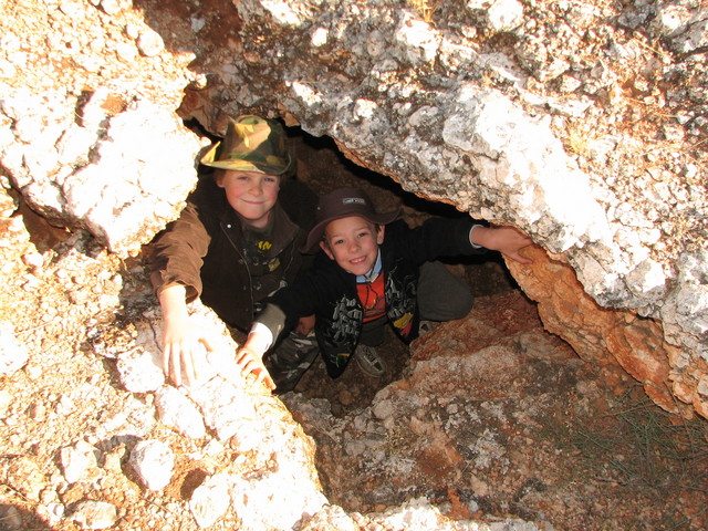 The boys inspecting a cave we found