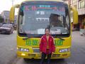 #4: 17-year-old ticket seller in front of bright yellow Yulin-to-Dayang bus.