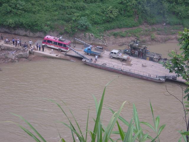 My bus driving off the vehicular ferry after crossing the Buliu River at Banai