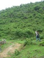#10: Ah Feng standing near the good path, taking a photo of the slope on which the confluence is located.