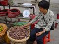 #2: Roadside vendor in Yongtai selling (and eating) dried persimmons.