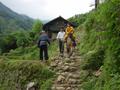 #5: Young girl on horseback, making her way down a stone path into Tielu from somewhere in the surrounding countryside