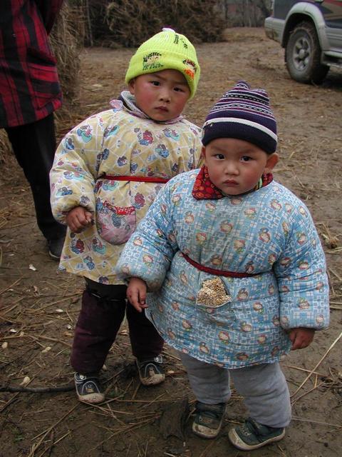 Toddlers in the village - very well bundled