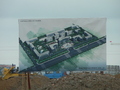 #4: Sign depicting future factory development, with work going on behind