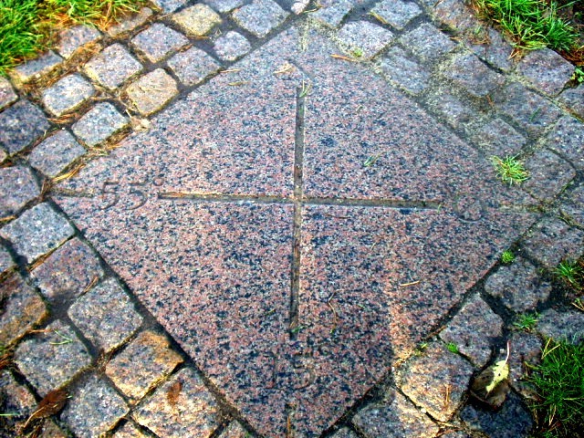 N55E15 granite marker in the ground