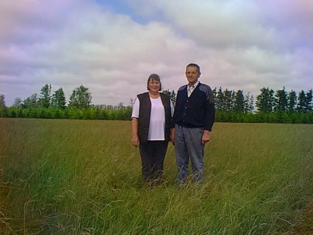 Looking north at Mr.and Mrs. Nygaard standing on the confluence, located on one of their fields.