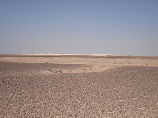 #1: View of general area taken from asphalt road looking in a NNW direction. Confluence lies approx. 8 km towards left of image
