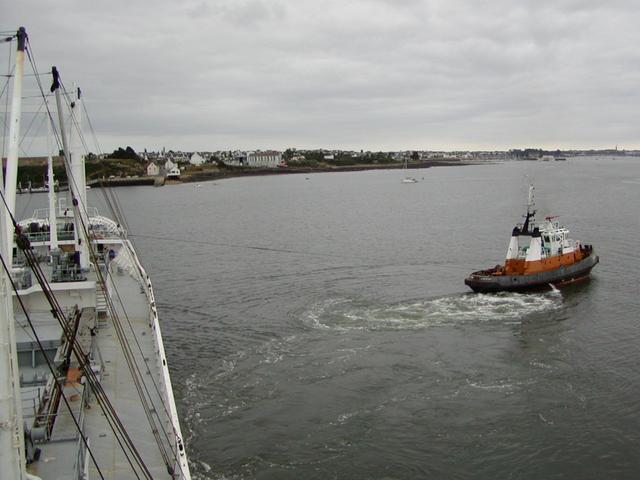 A tug towing our ship off the quay in Lorient