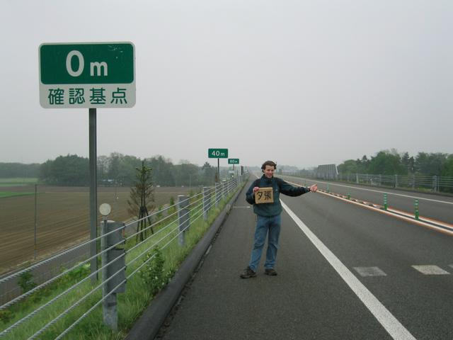 Hitchhiking on the expressway in the rain.