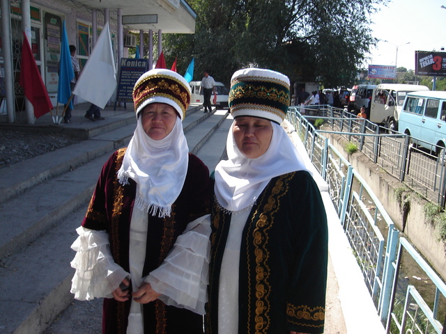 two kyrgysz women in traditionell dress attending the event