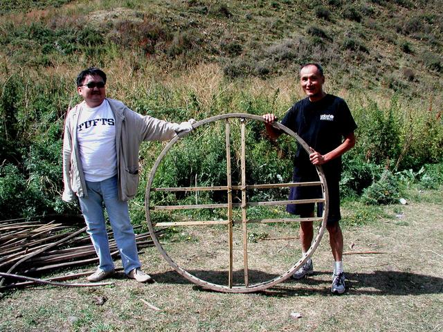 Ayadil and Ray holding the top structure of a yurt near the CP