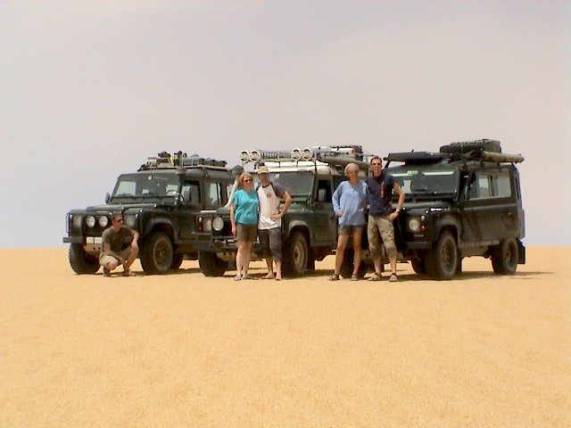 The Team in front of the Land Rovers
