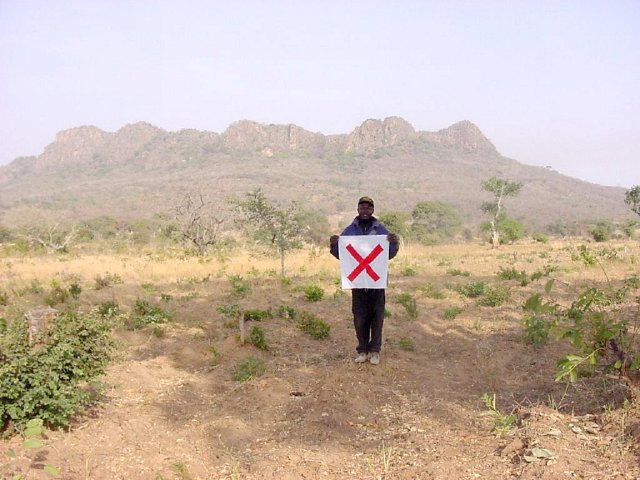 Ibrahim with the flag on the Confluence, looking west