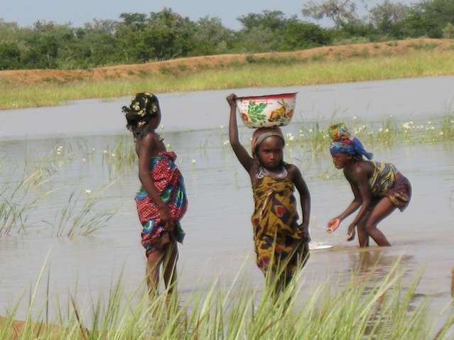 Fulani girls at a water reservoir