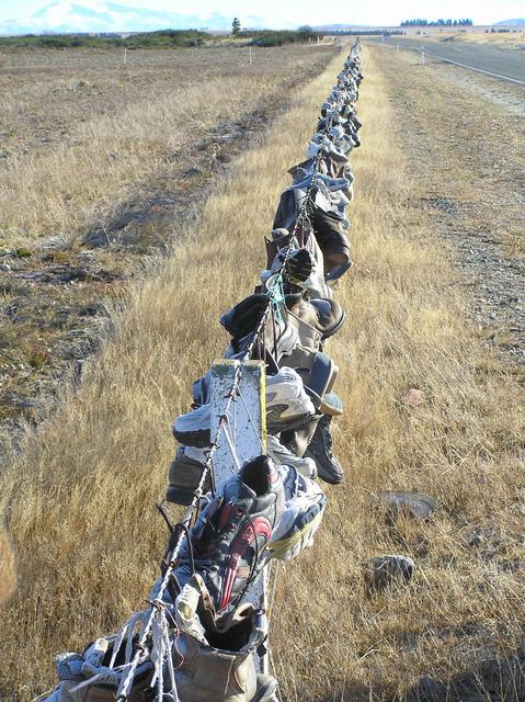 The Shoe Fence, contributed to by numerous passers-by over the years.
