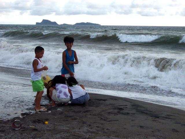 Children playing with the big waves