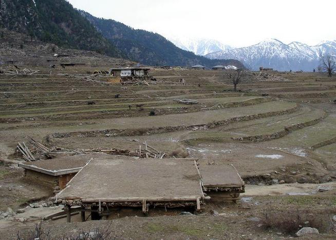 The village of Shera Kot.  The jumbles of lumber are structures destroyed in the earthquake.