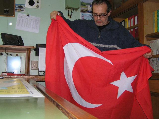 Captain Peter is folding up the Turkish flag