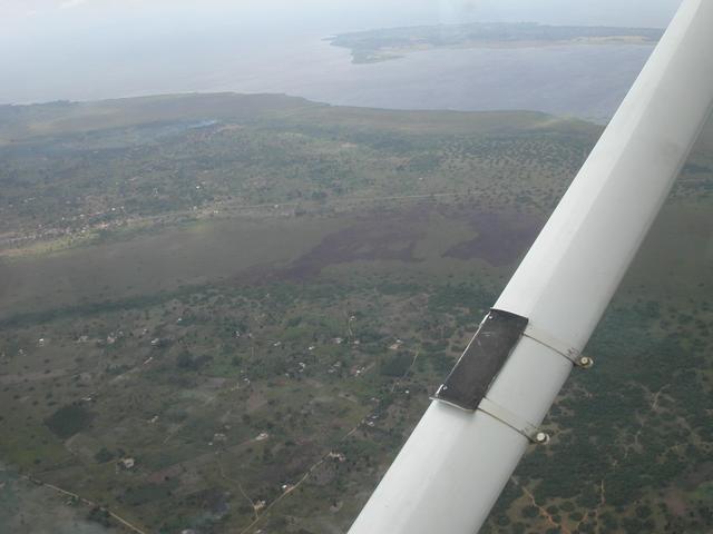 Aproximate location of the Confluence from the air (somewhere in the foreground). Lake Victoria and the main road from Kampala are in the background.