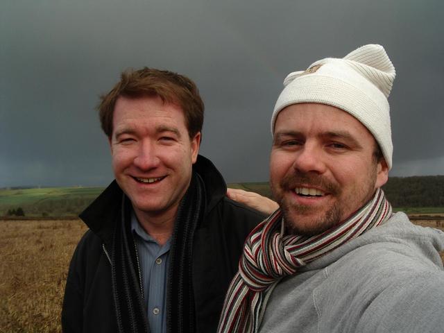 Clayton and me at the spot with grey sky and rainbow