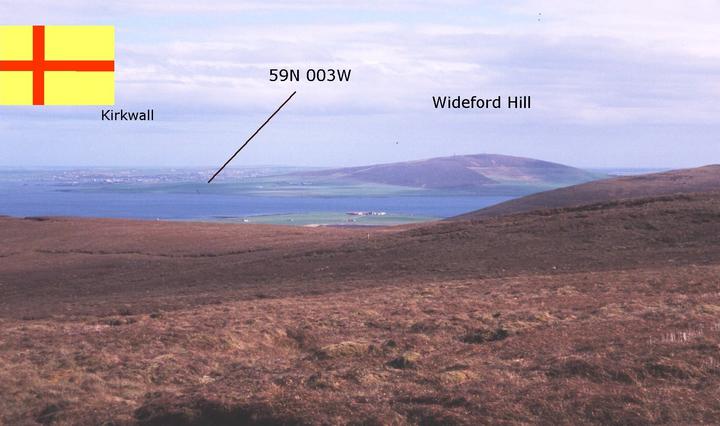 A distant view form Milldoe, a hill to the North. Inset: The Orkney Flag.