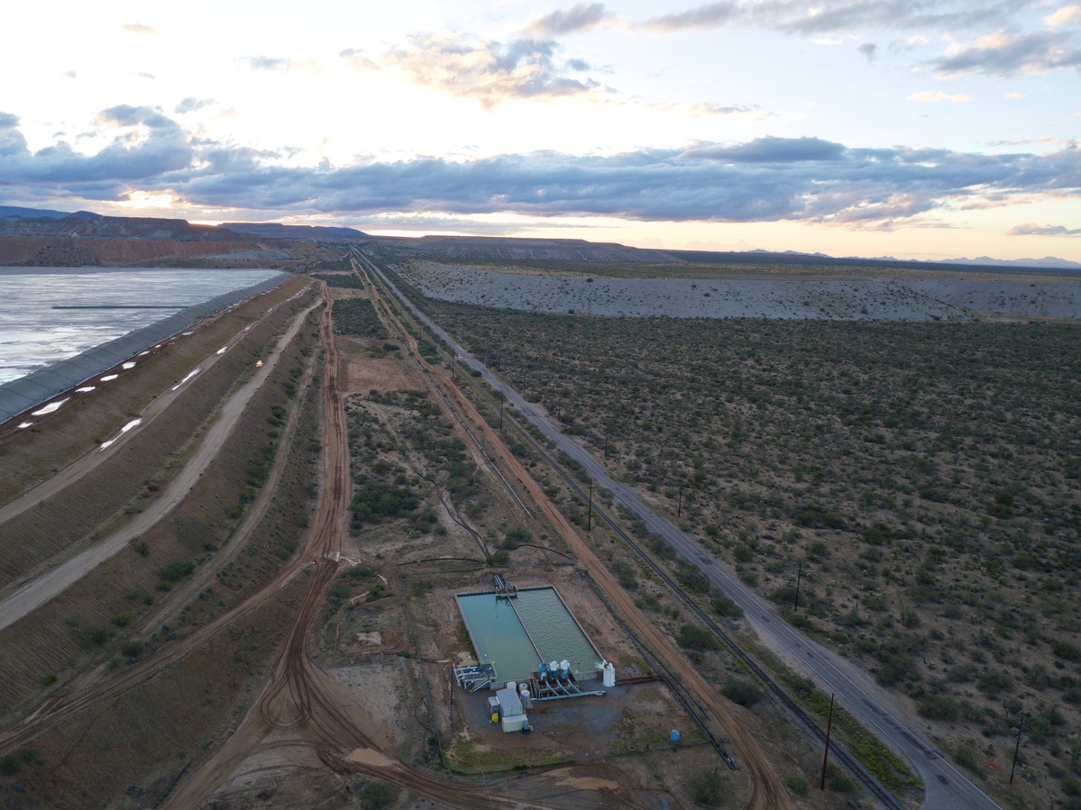 View West (along W. Pima Mine Road and the side of the reclamation pond, towards a large mine) from 120 m above the point)
