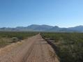 #8: Exiting along the dirt road, known as the Old Mormon Trail. In front are the southern peaks of the Beaver Dam Mountains.