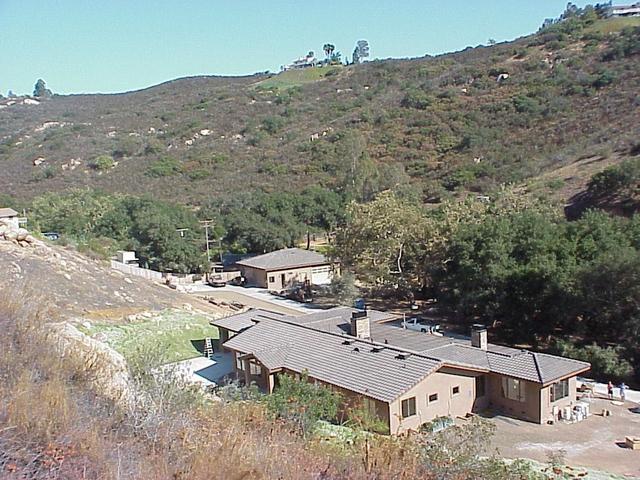 View to the east-southeast from the confluence, showing the new home and arroyo.