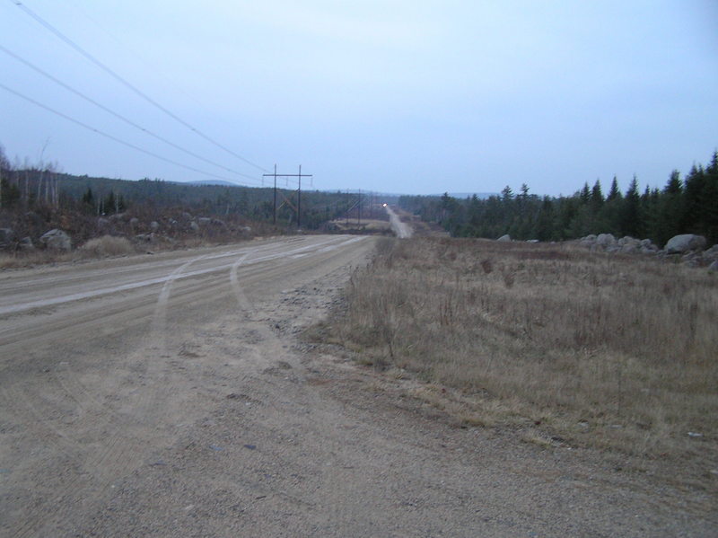 Looking east down the lonely road.  Notice the headlights from the logging truck, miles away.
