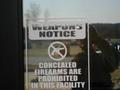 #7: his disturbing sign was seen just about everywhere I went...  Does EVERYONE in the US carry a gun these days?