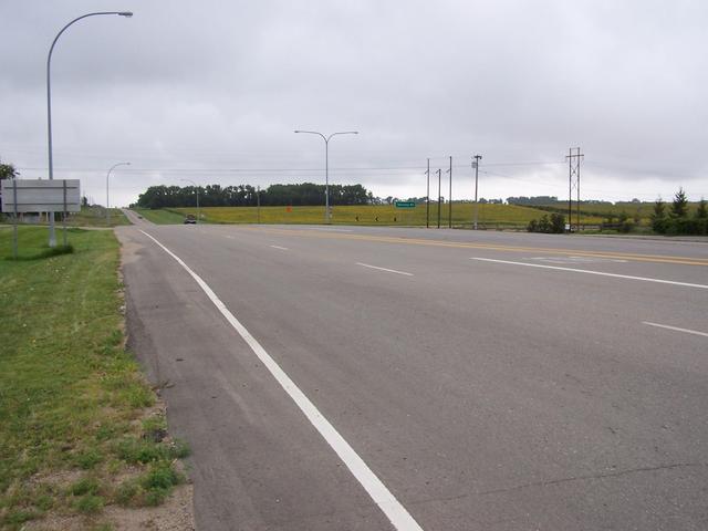 The view South along Highway 3 showing a field of sunflowers in the distance.