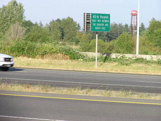 #1: The confluence point lies on this freeway on-ramp, in front of this car.  A sign notes the 45th parallel