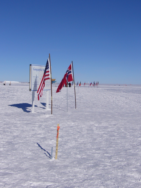 Pole history: centennial (wooden stake), 1<sup>st</sup> January 2011 (between two flags), former stakes and Ceremonial Pole (surrounded by flags)