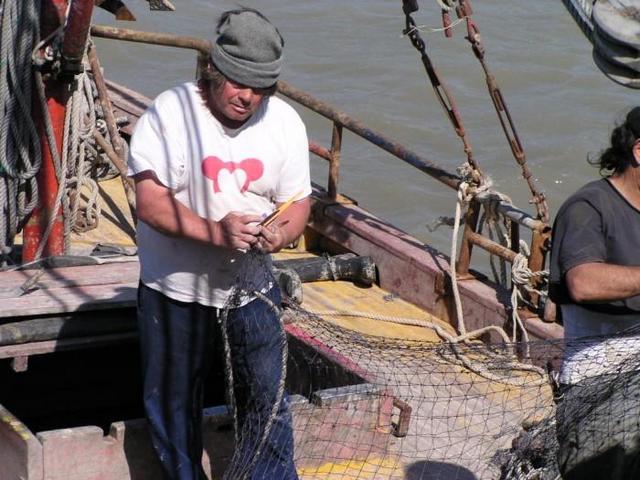repairing fishing nets on the "Siempre Amabile"