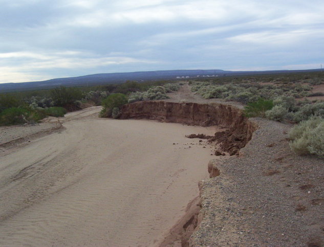 Dirty road cut by creek