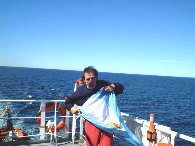 Captain Peter prepares the courtesy flag for hoisting
