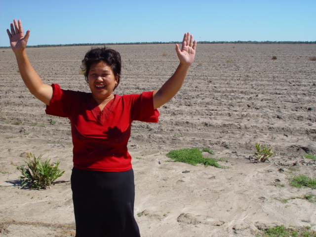 Liza Tully celebrates the find against the backdrop of the barren field