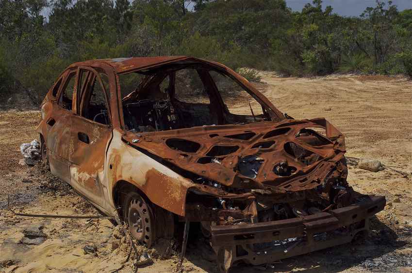 A wrecked, burned-out car, near the confluence point