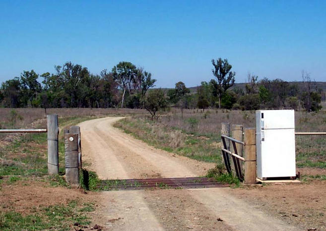 At the front gate.  I suppose they like to keep their mail cold?