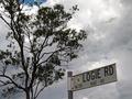 #9: The sign for the unsealed road, and the storm approaching the in the background.