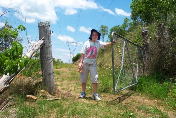 Lissa opens a gate on the powerline track