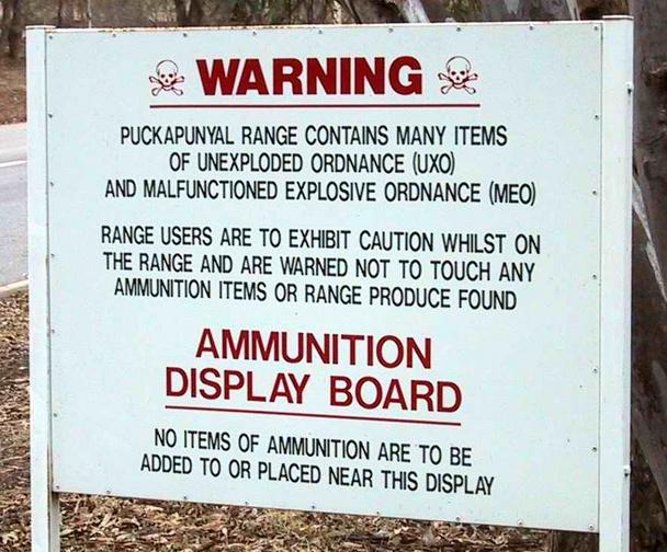 The sign warns of unexploded munitions