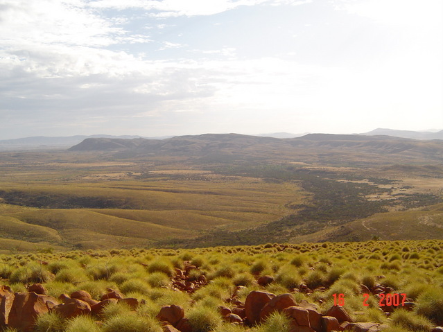 Looking ENE over the confluence point (unseeable, 125m down, 300m away at the bottom of the hil