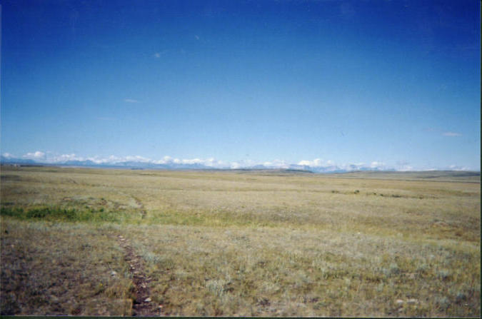 View of the Rocky Mountains from the plain above river
