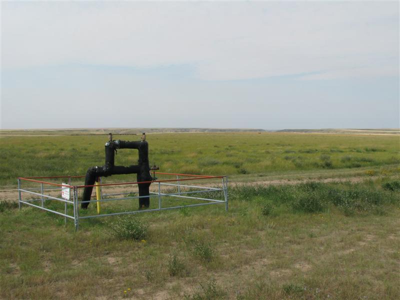 A few meters to the North of the confluence is oil industry equipment.  South Saskatchewan River valley can be seen in the distance.