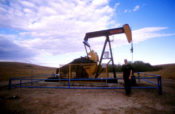 Mark beside oil well (confluence is behind the trees in the background).