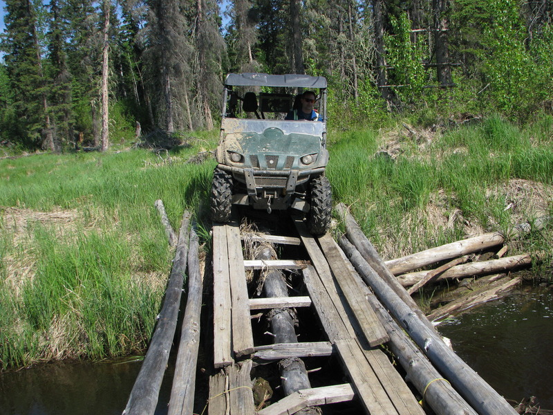 Greg driving the Rhino across the makeshift bridge