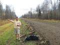 #5: Greg standing on the gravel/mud road with the bikes we walked there.