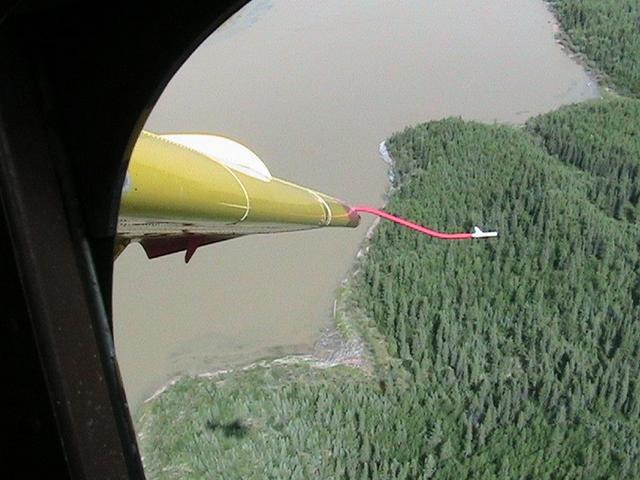 Overview.  The confluence is at the bottom end of the rock beach just above the wingtip.